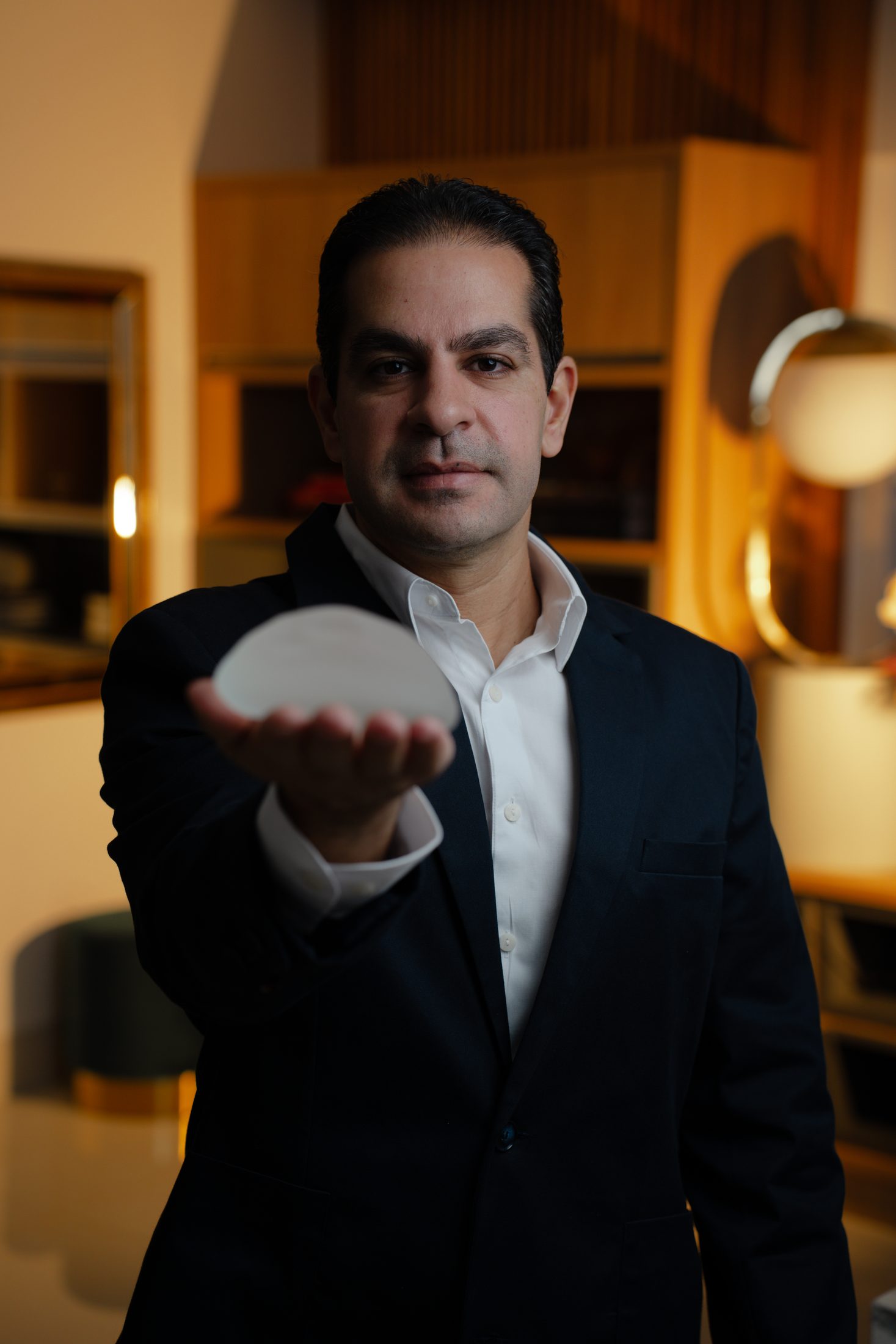 Plastic surgeon presenting a silicone implant in the consulting room